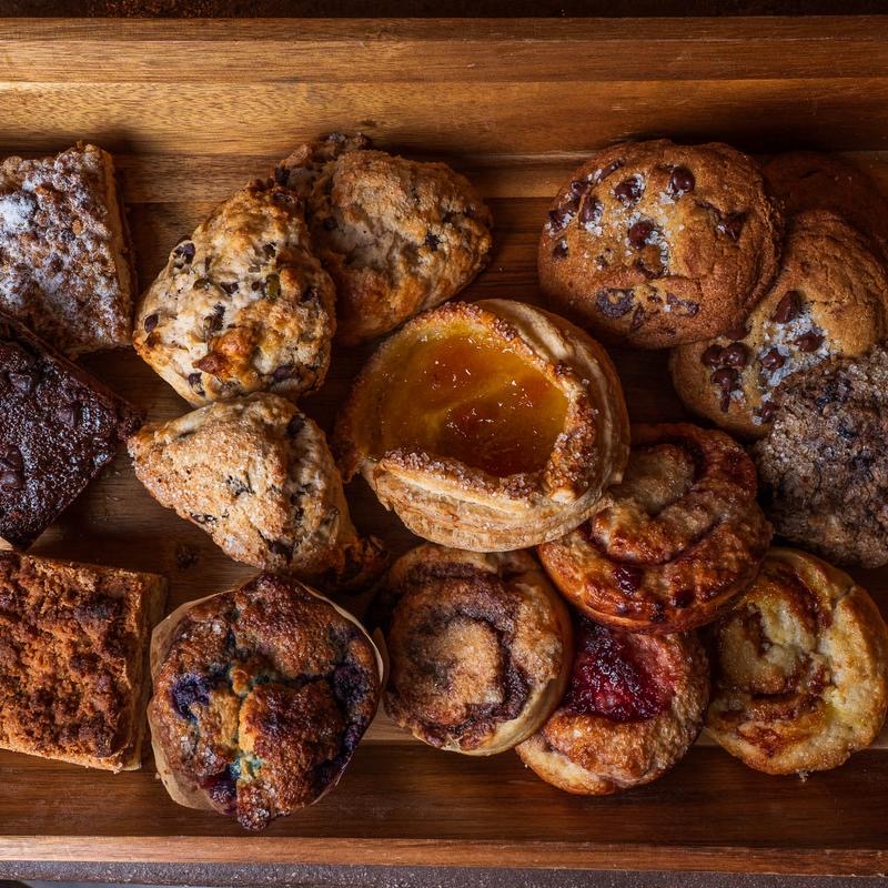 A wooden tray of assorted house-made scones and pastries